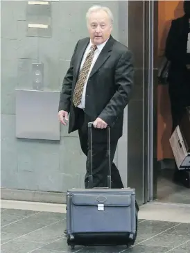  ?? FRANCIS VACHON FOR NATIONAL POST FILES ?? Quebec Superior Court Justice Michel Girouard leaves the courthouse in Quebec City. He is accused of buying illicit drugs in the back office of a video store.