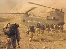  ?? Getty ?? American soldiers board a Chinook helicopter during the 2001 invasion of Afghanista­n