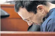  ??  ?? Larry Nassar hangs his head as former gymnast Amanda Thomashow gives her victim statement Tuesday in Ingham County Circuit Court in Lansing, Mich.