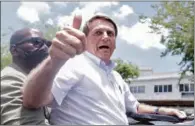  ?? (AFP) ?? Brazilian President Jair Bolsonaro gives the thumb up after voting during the second round of municipal elections in Rio de Janeiro on Sunday.