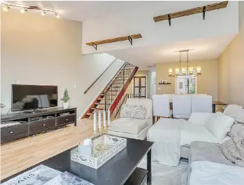  ??  ?? This Vancouver apartment on West 7th Avenue, which sold for $127,000 over its asking price, features wood floors and designer paint colours, with a stairway leading to the rooftop deck offering city and mountain views.