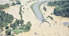  ?? — AFP ?? A part of a flooded highway exit is seen in a village in Matara.