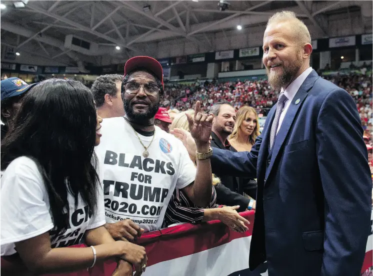  ?? SAUL LOEB / AFP / GETTY IMAGES ?? Brad Parscale, right, reelection campaign manager for U.S. President Donald Trump, speaks with supporters at a campaign rally, in Estero, Florida, in October.