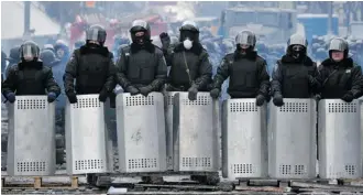  ?? Genya Savilov/AFP/Getty Images ?? Riot police form a barrier in central Kyiv earlier this week. Calgary’s Marc Chikinda, whose grandparen­ts emigrated from Ukraine, fears for the country’s future under its despotic president.