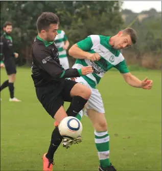  ??  ?? Ross Reardon of Gorey Celtic battles for the ball with Alan Freeman of Shamrock Rovers.