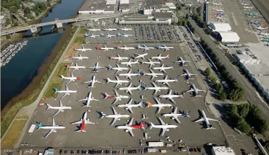  ?? (Lindsey Wasson/Reuters) ?? GROUNDED BOEING 737 MAX aircraft are seen parked in a storage lot at Boeing Field in Seattle, earlier this month.