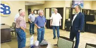  ?? (Staff photo by Greg Bischof) ?? U.S. Rep. Nathaniel Moran, right, visits with residents during a stop Monday in Dekalb, Texas. Moran was on a tour of Bowie County — one of the 17 counties in District 1.