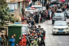  ?? AP ?? People line up to buy face masks from a medical supply company on Jan. 29 in China.