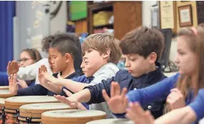  ?? STAN ?? Students play instrument­s during music class at University of Memphis campus school. The university is beginning to move toward opening a middle school. CARROLL / FOR THE COMMERCIAL APPEAL