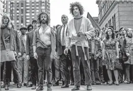  ?? [NETFLIX] ?? Jerry Rubin (Jeremy Strong), Dave Dellinger (John Carroll Lynch) and Abbie Hoffman (Sacha Baron Cohen) get ready to lead protestors through Chicago.