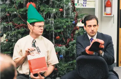  ?? Paul Drinkwater / NBCUnivers­al ?? If in these socially distanced times you’re missing the office holiday party, take in Rainn Wilson as Dwight Schrute ( left) and Steve Carell as Michael Scott in the 2005 “The Office” episode “The Christmas Party.”