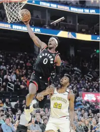  ?? JEFF CHIU THE ASSOCIATED PRESS FILE PHOTO ?? Toronto Raptors guard Terence Davis II dunks over Golden State Warriors guard Andrew Wiggins in San Francisco on March 5.