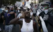  ?? CHARLIE RIEDEL—ASSOCIATED PRESS ?? In this June 20, 2020, file photo, demonstrat­ors march outside the BOK Center where President Trump will hold a campaign rally in Tulsa, Okla.