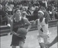  ?? The Sentinel-Record/Richard Rasmussen ?? SEASON FINALE: Lakeside senior Ashton Patrick, left, drives against Hot Springs junior Alivia Erby (4) Tuesday at Trojan Fieldhouse during the Lady Rams’ season-ending 48-33 defeat.