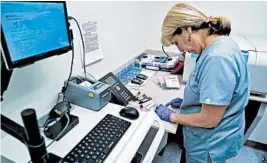  ?? DAKE KANG/AP 2017 ?? Nurse Stephanie Richurk sorts blood samples from participan­ts in the All of Us research program in Pittsburgh.