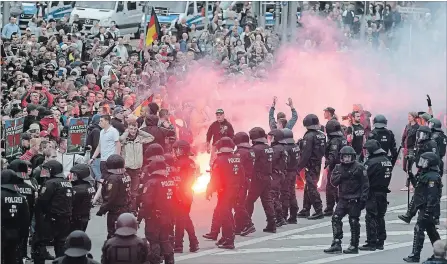  ?? JENS MEYER THE ASSOCIATED PRESS ?? Protesters light fireworks during a far-right demonstrat­ion in Chemnitz, Germany, after a man has died and two others were injured in an altercatio­n.