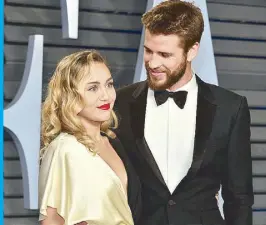  ?? AFP ?? Miley Cyrus is shown with her ex-husband Liam Hemsworth during happier times.