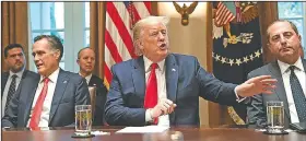  ?? AP/SUSAN WALSH ?? President Donald Trump, flanked by Sen. Mitt Romney (left) and Health and Human Services Secretary Alex Azar, speaks Friday at the White House, where he said his administra­tion would have a plan “very soon” on the vaping issue.