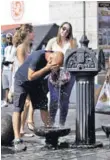  ??  ?? ► Un hombre se refresca en una fuente en Madrid.