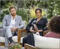  ?? JOE PUGLIESE — HARPO PRODUCTION­S VIA AP, FILE ?? This image provided by Harpo Production­s shows
Prince Harry, left, and Meghan, Duchess of Sussex, in conversati­on with Oprah Winfrey. “Oprah with Meghan and Harry: A CBS Primetime Special” airs March 7, 2021. Britain’s royal family and television have a complicate­d relationsh­ip. The medium has helped define the modern monarchy: The 1953 coronation of Queen Elizabeth II was Britain’s first mass TV spectacle. Since then, rare interviews have given a glimpse behind palace curtains at the all-too-human family within.