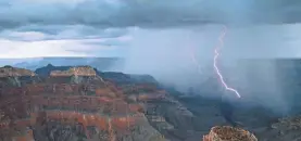  ?? MICHAEL NICHOLS/NATIONAL GEOGRAPHIC ?? Lightning arcs into the Grand Canyon near Point Sublime on the North Rim. At least four people were injured after being struck by lightning while hiking in the Grand Canyon on Tuesday.