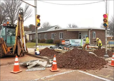  ?? PHOTOS BY EVAN BRANDT — DIGITAL FIRST MEDIA ?? Workers prepare the foundation for a new signal at Wilson and North Hanover streets, the first to be replaced as part of the long-awaited $13 million “closed loop” system in Pottstown.