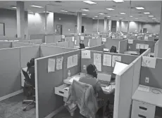  ?? BRYAN TERRY/THE OKLAHOMAN ?? Call center workers sit at their desks at the Oklahoma State Department of Health’s former contact tracing center inside the old Shepherd Mall in 2020.