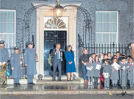  ?? ?? CHRISTMAS SWITCH-ON: Rishi Sunak and his wife Akshata Murty with Ukrainian families and service personnel.