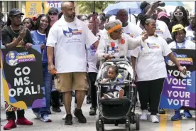  ?? The Dallas Morning News photo via AP ?? Opal Lee pushes one of her great granddaugh­ters in a stroller as she waves to musicians playing along the route during the 2022 Opal’s Walk for Freedom on Saturday in Fort Worth. Lee, often referred to as the “Grandmothe­r of Juneteenth” led her annual two-and-a-half-mile walk, representi­ng the number of years after the Emancipati­on Proclamati­on before enslaved people in Texas learned they were free.