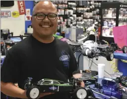  ?? PHOTO TOM BODUS ?? Danny Tomboc, of Brawley, is shown here with one of the three RC vehicles he had entered in the 4th annual ProLine Carpet Classic at Ricochet R/C Raceway in Imperial.