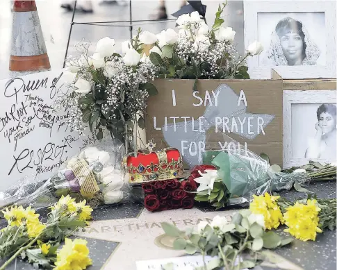 ?? AP ?? Flowers and signs are placed on Aretha Franklin’s star at the Hollywood Walk of Fame yesterday in Los Angeles.