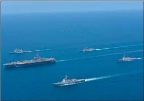  ?? (AP/Japan Maritime Self-Defense Force) ?? USS Abraham Lincoln (left), and JS Kongo (front), sail in formation during a U.S.-Japan bilateral exercise in the Sea of Japan on Tuesday.