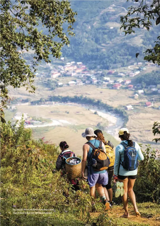  ??  ?? Ker, Jacqueli, Wessel and Shivani walk down a steep slope en route to their overnight accommodat­ion.