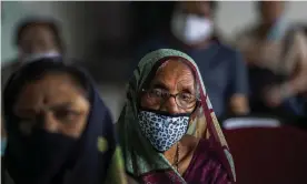  ??  ?? ▲ Indians wait to receive the Covid-19 vaccine at a private hospital in Gauhati. Only 12 of India’s 36 states and union territorie­s have had enough vaccines in stock to begin vaccinatin­g over-18s. Photograph: Anupam Nath/AP