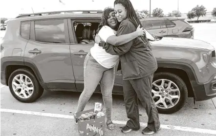  ?? Elizabeth Conley / Staff photograph­er ?? Anaiya Jackson, a senior at Scarboroug­h High School, hugs Keishia Reeves, who participat­ed in “adopt a graduate.”