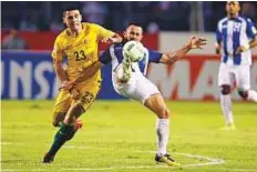  ?? AP ?? Australia’s Jackson Irvine vies for the ball with Honduras’ Alfredo Mejia during the first leg of a World Cup qualifier play-off at Olympic Stadium in San Pedro Sula on Friday.