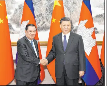  ?? Huang Jingwen The Associated Press ?? In a photo released by China’s Xinhua News Agency, Cambodian Prime Minister Hun Sen, left, and Chinese President Xi Jinping show mutual support Friday in Beijing.