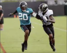  ?? JOHN RAOUX — THE ASSOCIATED PRESS FILE ?? In this file photo, Jaguars cornerback Jalen Ramsey (20) defends receiver D.J. Chark Jr. during a practice at training camp in Jacksonvil­le, Fla.