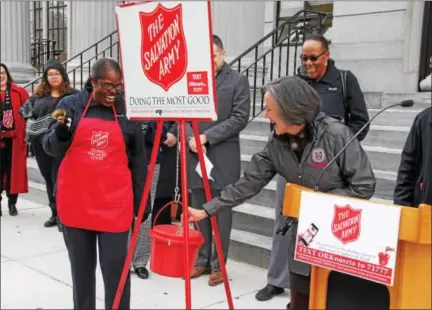  ?? SUBMITTTED PHOTO ?? Montgomery County Commission­ers’ Chairwoman Valerie Arkoosh makes the first donation to The Salvation Army of Norristown’s Red Kettle Campaign during its kick-off celebratio­n at the Montgomery County Courthouse Tuesday.