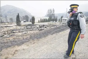  ?? CP PHOTO ?? The area of Boston Flats, B.C., is pictured July 11 after a wildfire ripped through the area earlier in the week. The new British Columbia government is extending the state of emergency for another two weeks as wildfires continue to sweep across the...