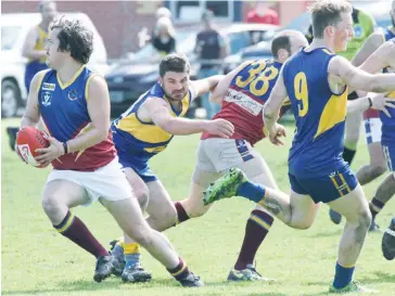  ??  ?? Warragul Industrial­s player Zac O’Hara breaks away from the pack.