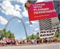  ?? AP PHOTO/JEFF ROBERSON ?? Abortion-rights supporters stand on both sides of a street near the Gateway Arch in May as they take part in a St. Louis protest in favor of reproducti­ve rights.