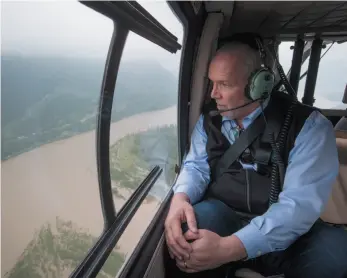  ?? CP PHOTO ?? Premier John Horgan looks out at the swollen Fraser River near Hope during an aerial tour of potential flood areas on Wednesday.