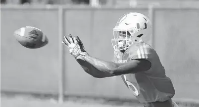  ?? WILFREDO LEE/AP ?? Miami wide receiver Mark Pope catches a pass during practice in 2019. son of a gun coming across that middle.”