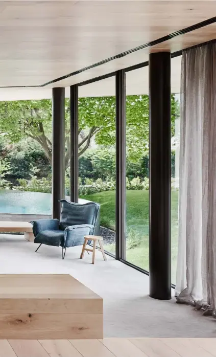  ??  ?? Family room With wraparound views of the garden and swimming pool, this space is given a warmer feel via the ceiling and cabinetry, which is finished in oak. ‘Off Cut’ stools by Tom Dixon feature alongside a ‘Cloudscape’ armchair, a collaborat­ion between Diesel Living and Moroso, and a modular ‘Cloud’ sofa by Sanja Knezović for Prostoria. The wall light is the ‘Counterbal­ance’ by Daniel Rybakken for Luceplan