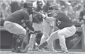  ?? GETTY IMAGES ?? Ji-Man Choi (right) is greeted a home plate by Jonathan Villar after belting a pinch-hit grand slam for the Brewers on Saturday afternoon.