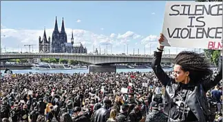  ?? MARTIN MEISSNER / AP FILE ?? In this June 6 photo, thousands of people demonstrat­e in Cologne, Germany, to protest against racism and the recent killing of George Floyd.