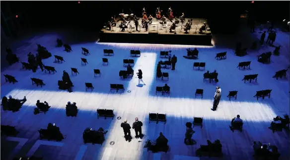  ?? Pic: Getty ?? Vaccinated or Covid-tested music fans arrive to hear the New York Philharmon­ic at The Shed in Brookfield Place in New York City, the orchestra’s first live performanc­e in 13 months