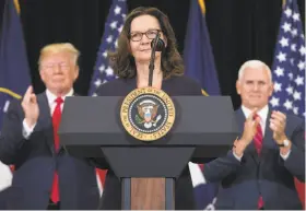  ?? Saul Loeb / AFP / Getty Images ?? Gina Haspel speaks after being sworn in as the new CIA director alongside a clapping President Trump and Vice President Mike Pence.