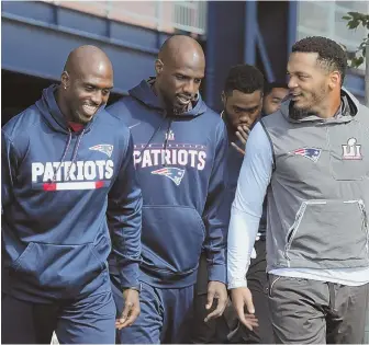  ?? Staffphoto­byJohNWILC­oX ?? KEEPING IT TOGETHER: Devin McCourty (left) walks out to the practice field with fellows defensive backs Duron Harmon (center) and Patrick Chung yesterday.